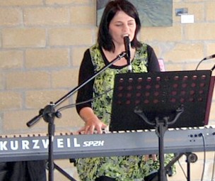 Nicole playing piano at Hot Waves Cafe